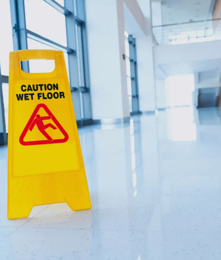 A yellow caution sign marking a wet floor